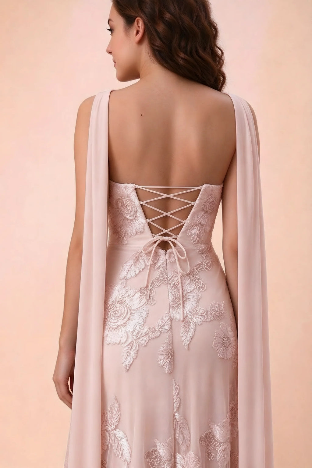 Close-up of Carey light pink crossed back lacing with scarf ends over the shoulders