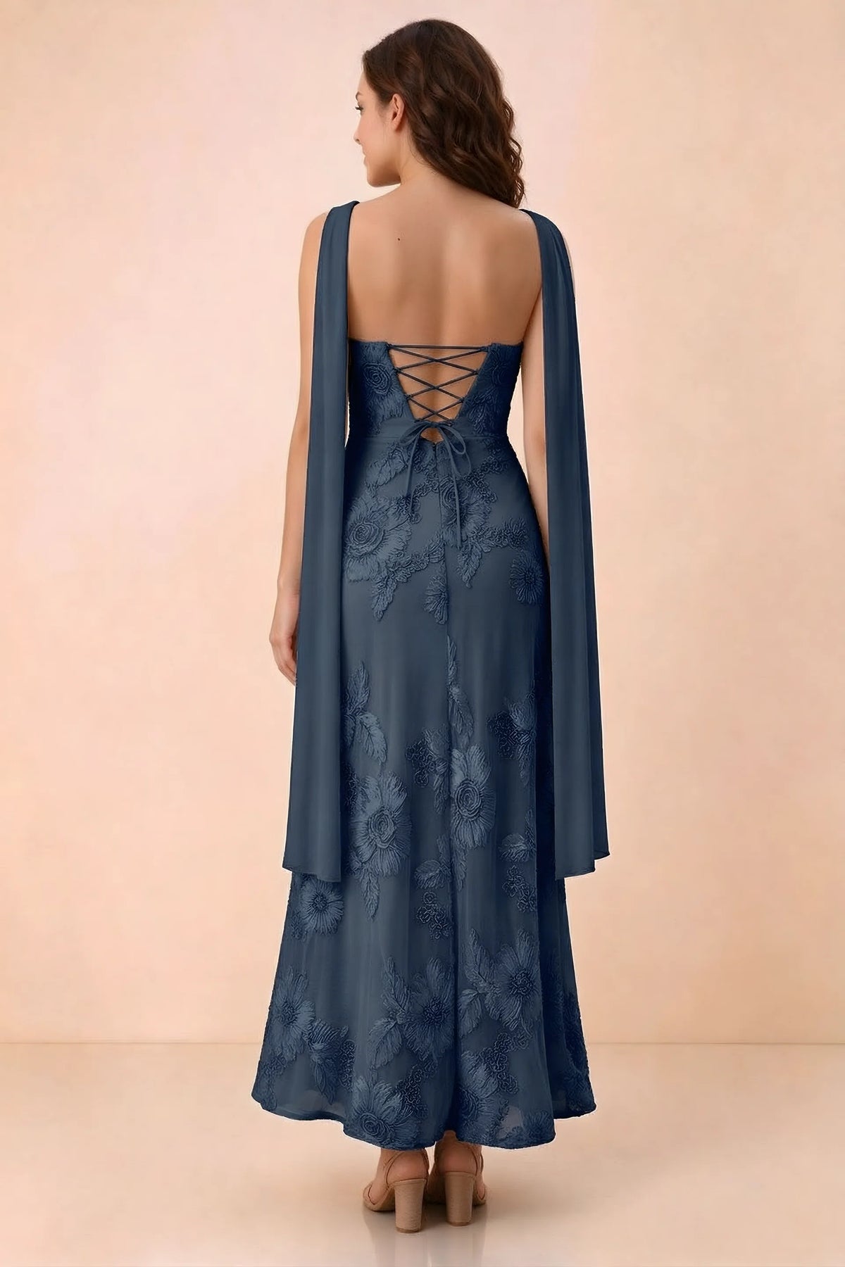 Rear studio view of Carey navy dress showing crossed back lacing and scarf ends draped over the shoulders