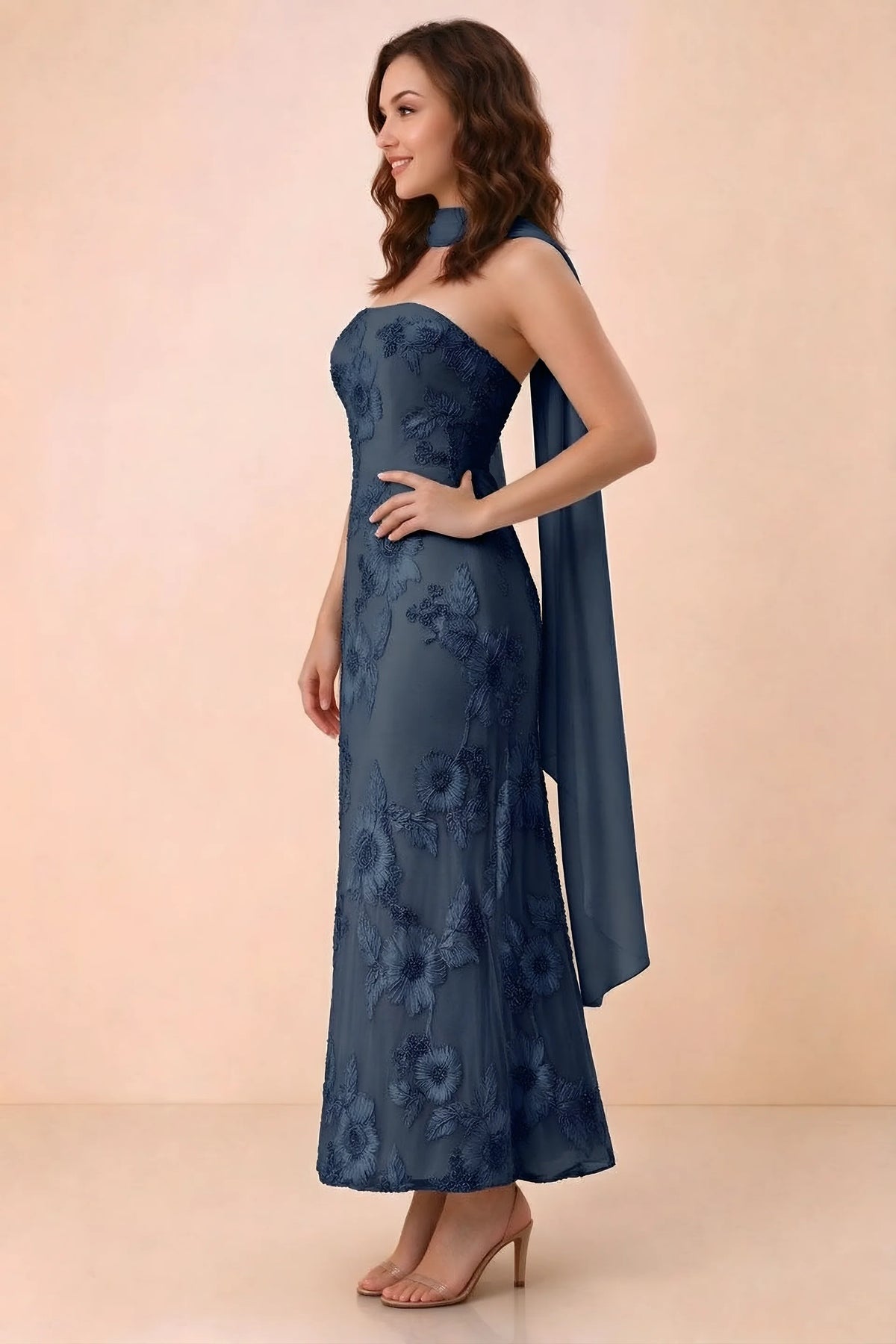 Three-quarter studio view of Carey navy strapless dress showing the fitted waist and floral appliques