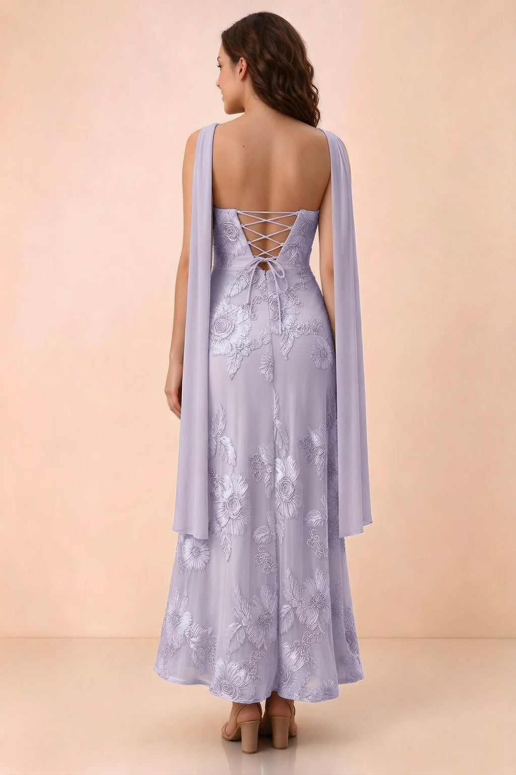 Rear studio view of Carey pale purple dress showing crossed back lacing and scarf ends draped over the shoulders