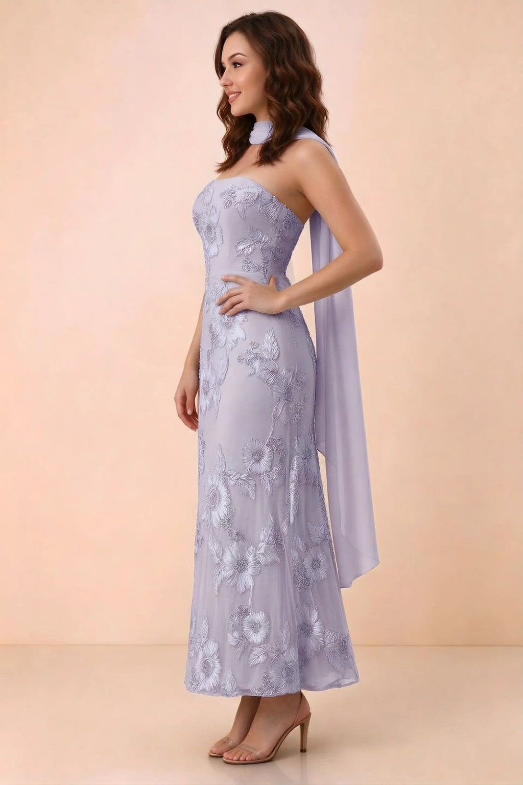 Three-quarter studio view of Carey pale purple strapless dress showing the fitted waist and floral appliques