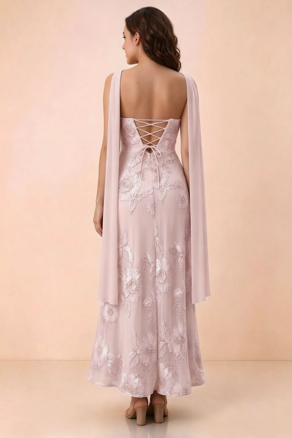 Rear studio view of Carey pink dress showing crossed back lacing and scarf ends draped over the shoulders