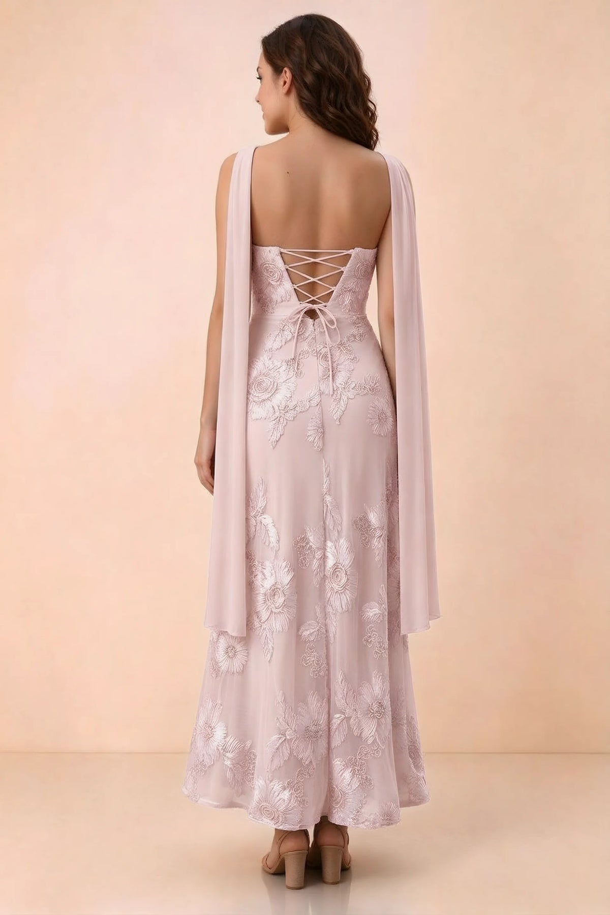 Rear studio view of Carey pink dress showing crossed back lacing and scarf ends draped over the shoulders