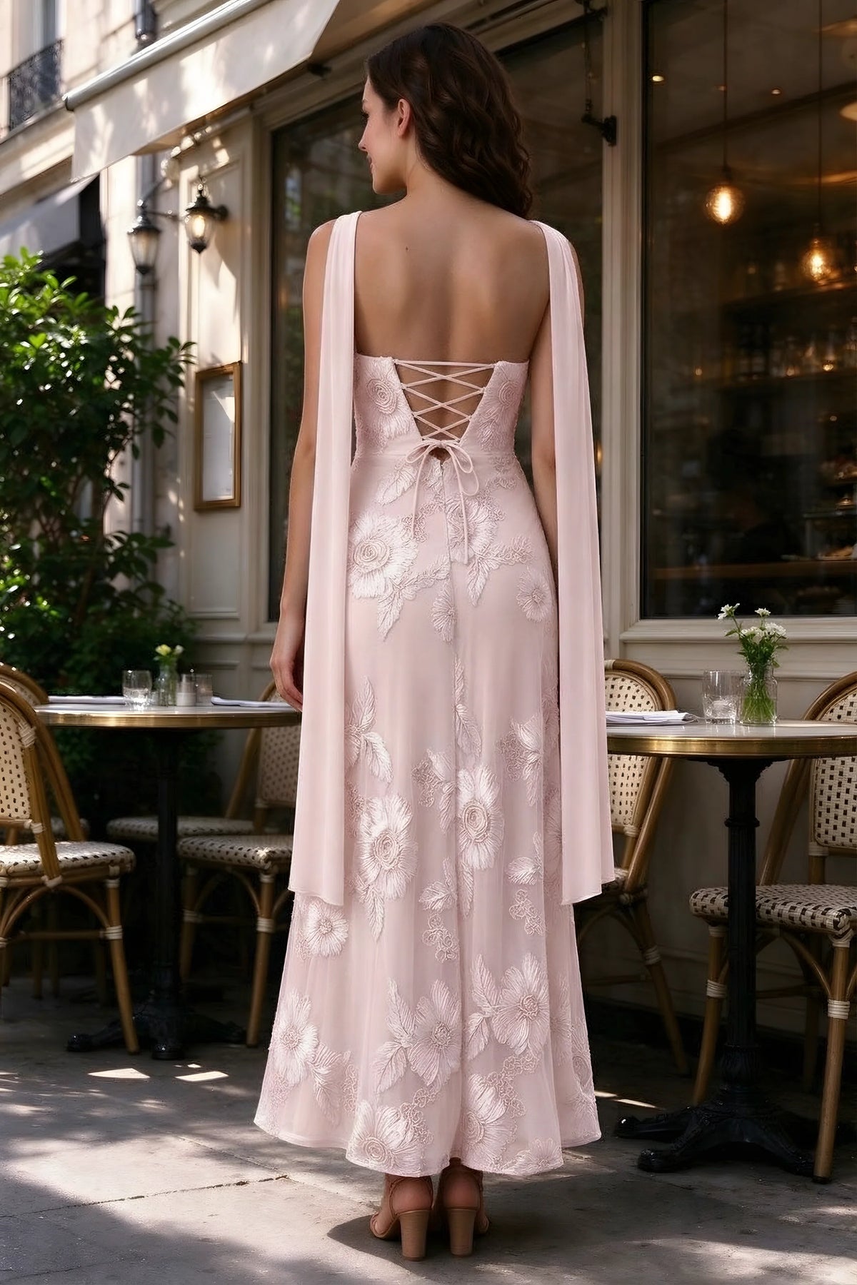 Outdoor rear view of Carey pink dress showing the lace-up back and long scarf ends