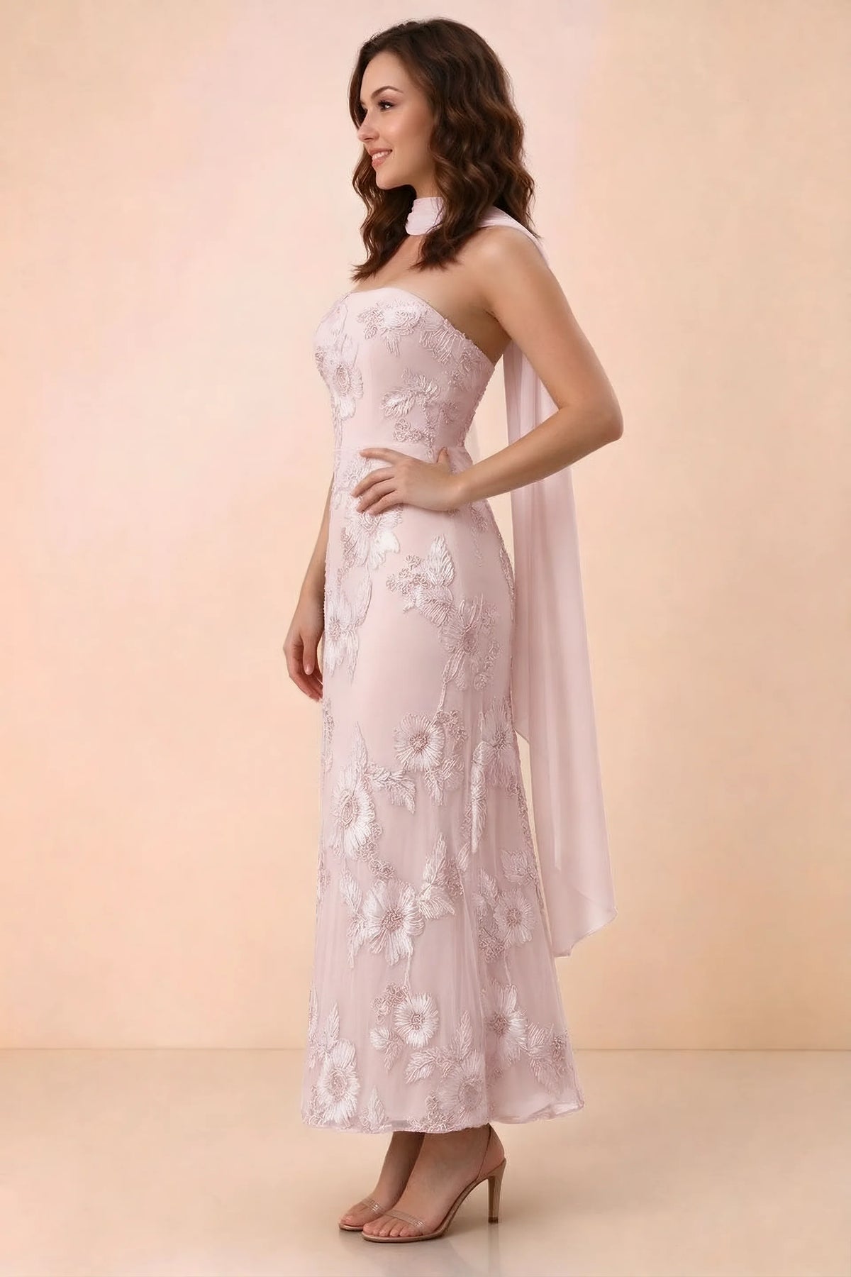 Three-quarter studio view of Carey pink strapless dress showing the fitted waist and floral appliques