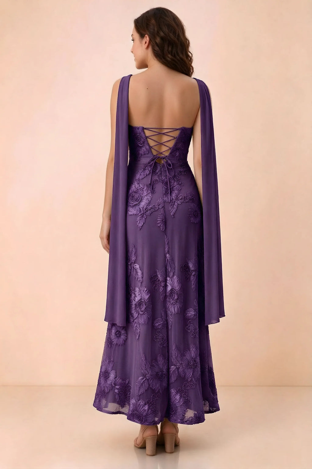 Rear studio view of Carey plum dress showing crossed back lacing and scarf ends draped over the shoulders