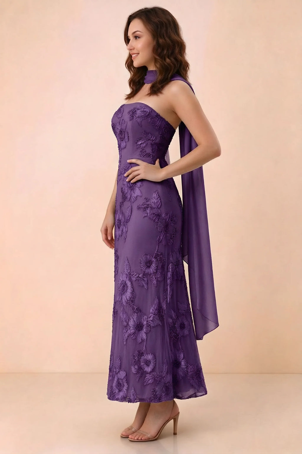 Three-quarter studio view of Carey plum strapless dress showing the fitted waist and floral appliques