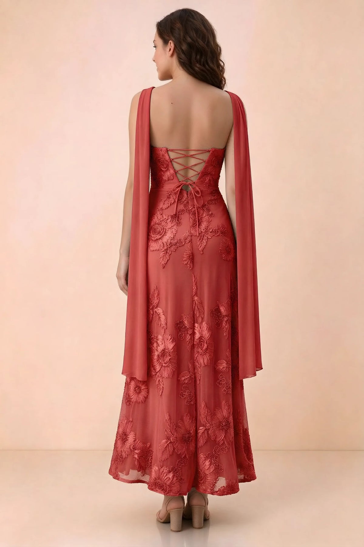 Rear studio view of Carey red dress showing crossed back lacing and scarf ends draped over the shoulders