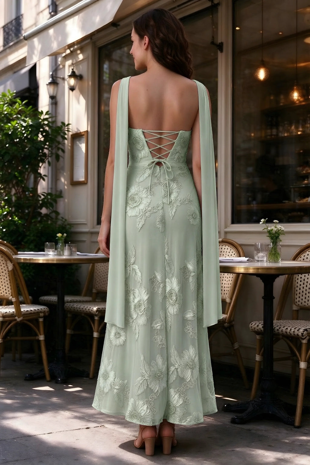 Outdoor rear view of Carey sage green dress showing the lace-up back and long scarf ends