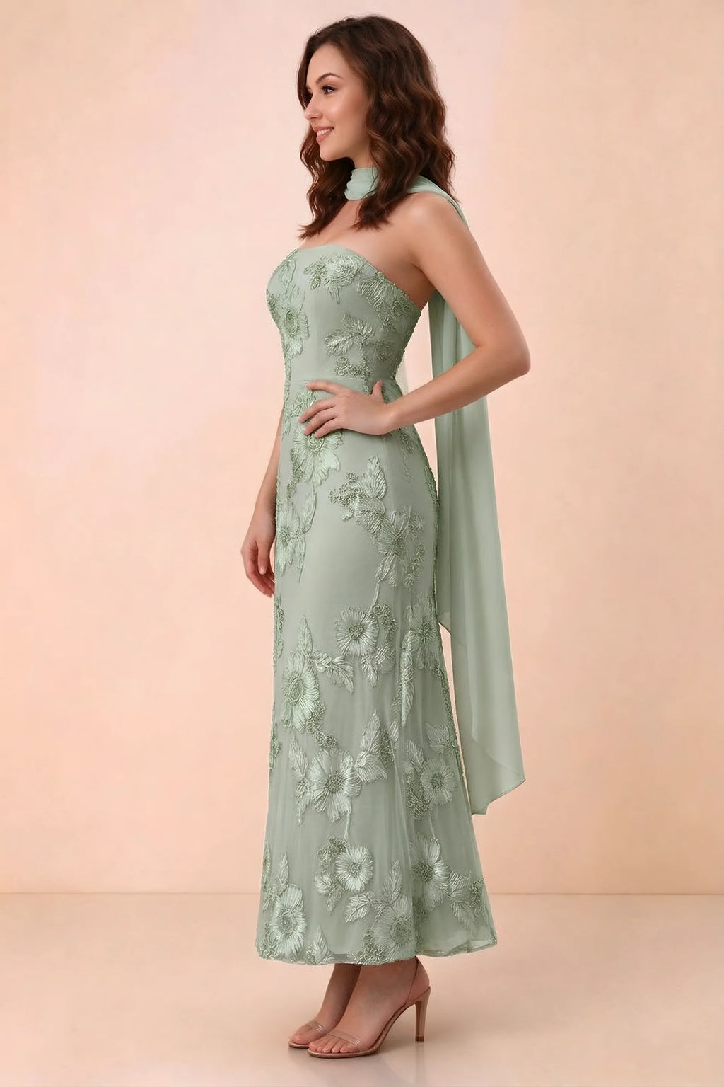 Three-quarter studio view of Carey sage green strapless dress showing the fitted waist and floral appliques