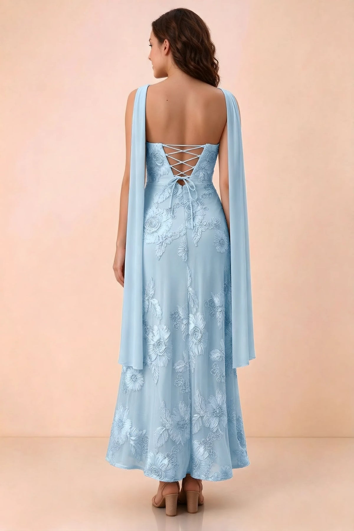 Rear studio view of Carey sky blue dress showing crossed back lacing and scarf ends draped over the shoulders
