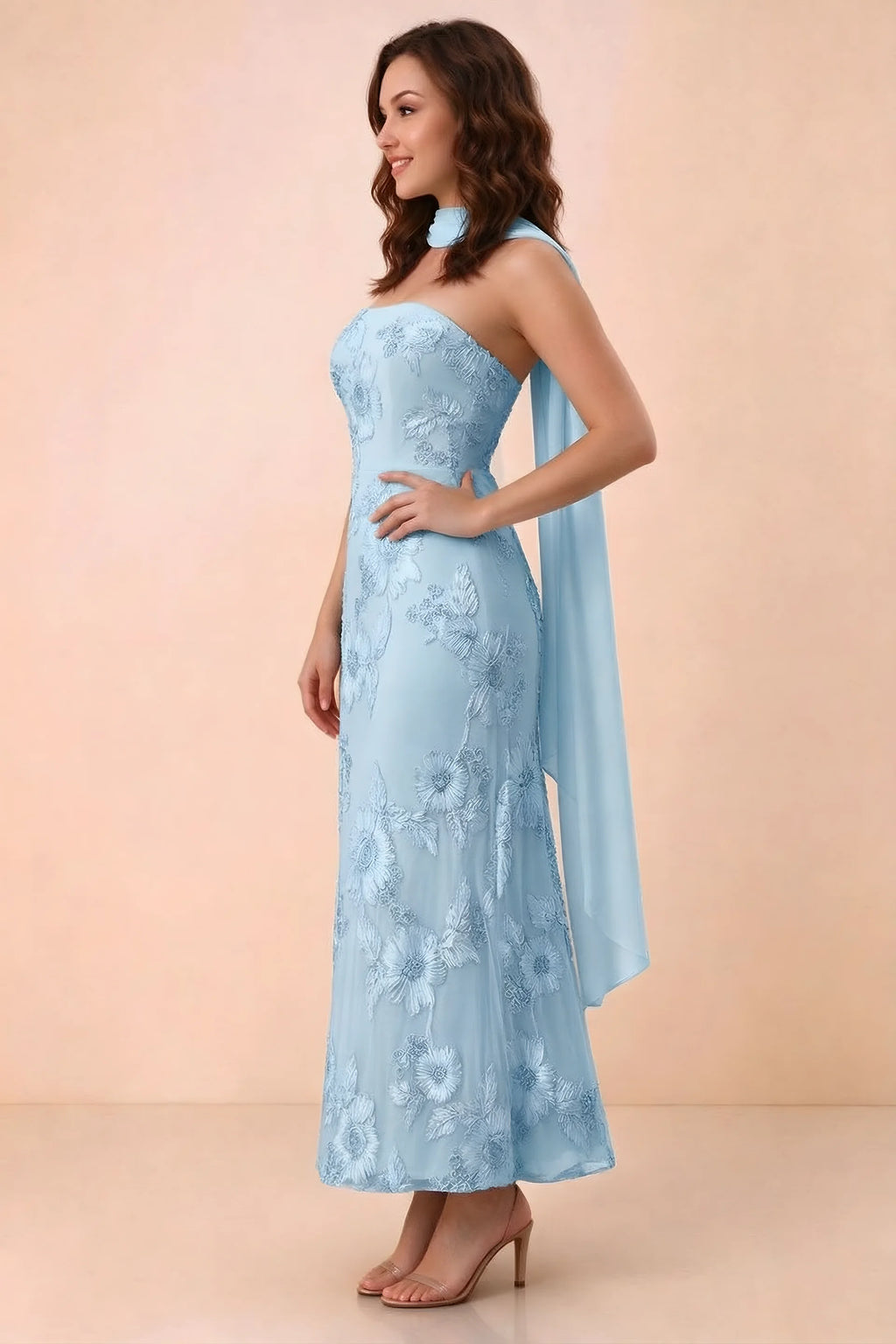 Three-quarter studio view of Carey sky blue strapless dress showing the fitted waist and floral appliques