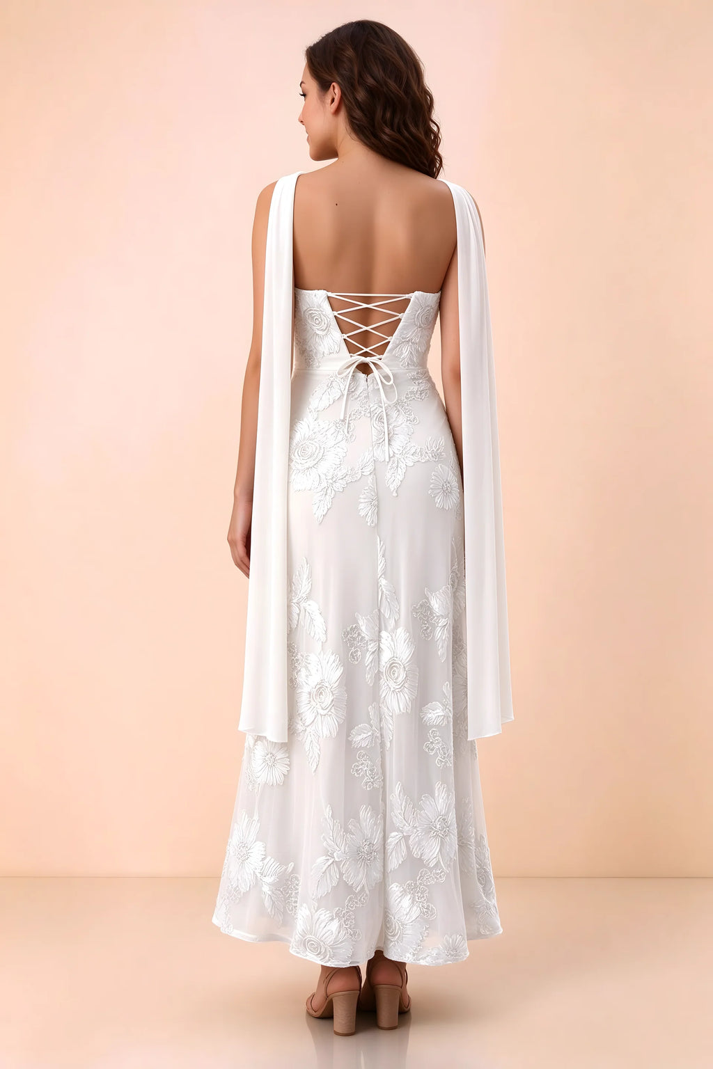Rear studio view of Carey white dress showing crossed back lacing and scarf ends draped over the shoulders