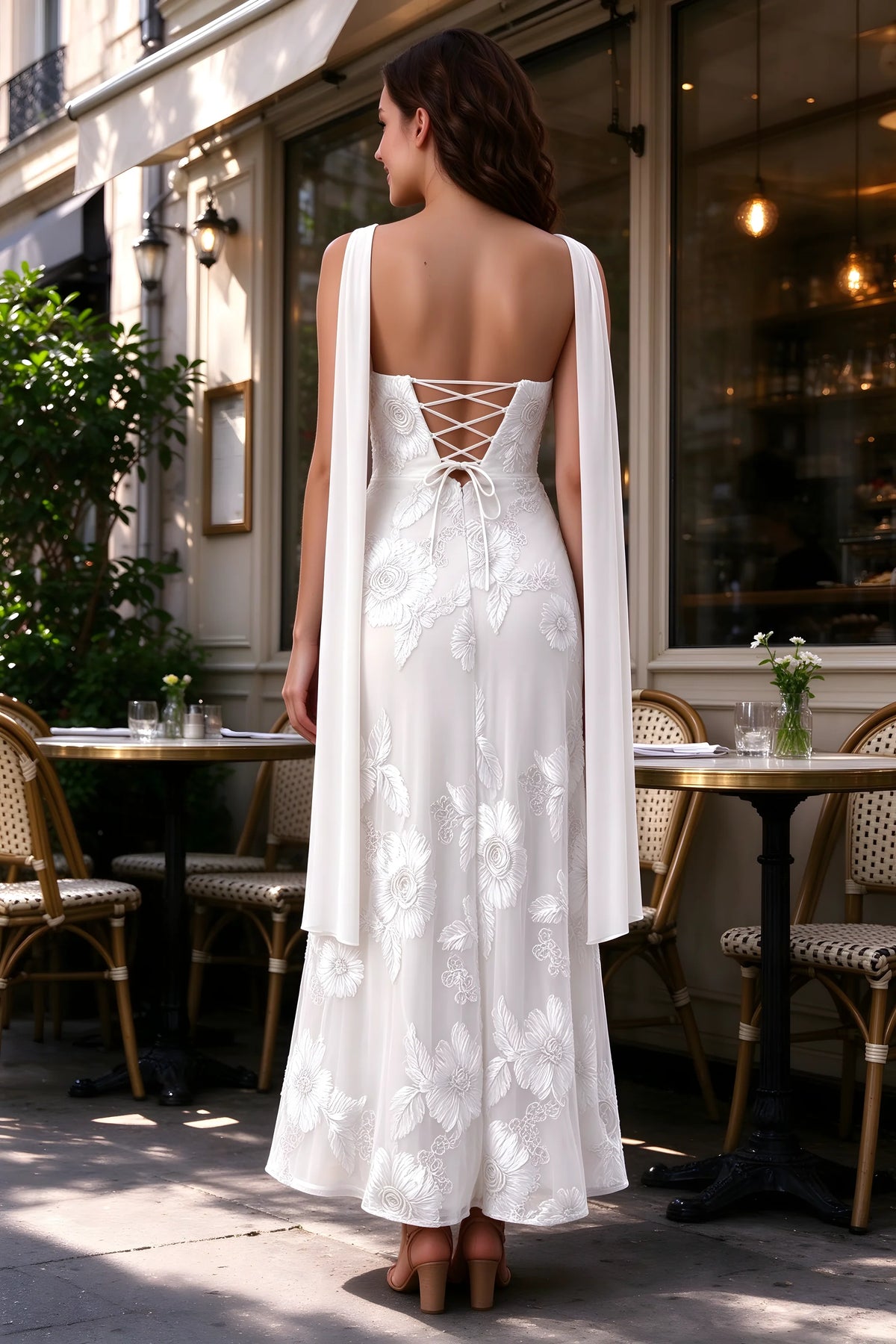 Outdoor rear view of Carey white dress showing the lace-up back and long scarf ends