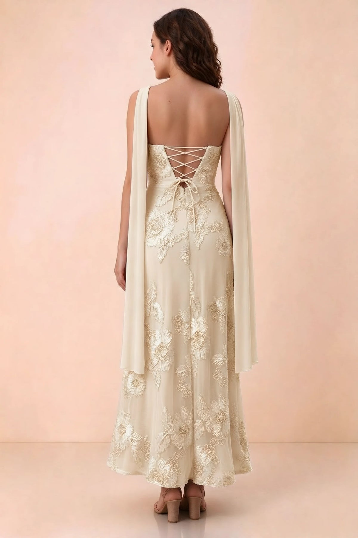 Rear studio view of Carey yellow dress showing crossed back lacing and scarf ends draped over the shoulders