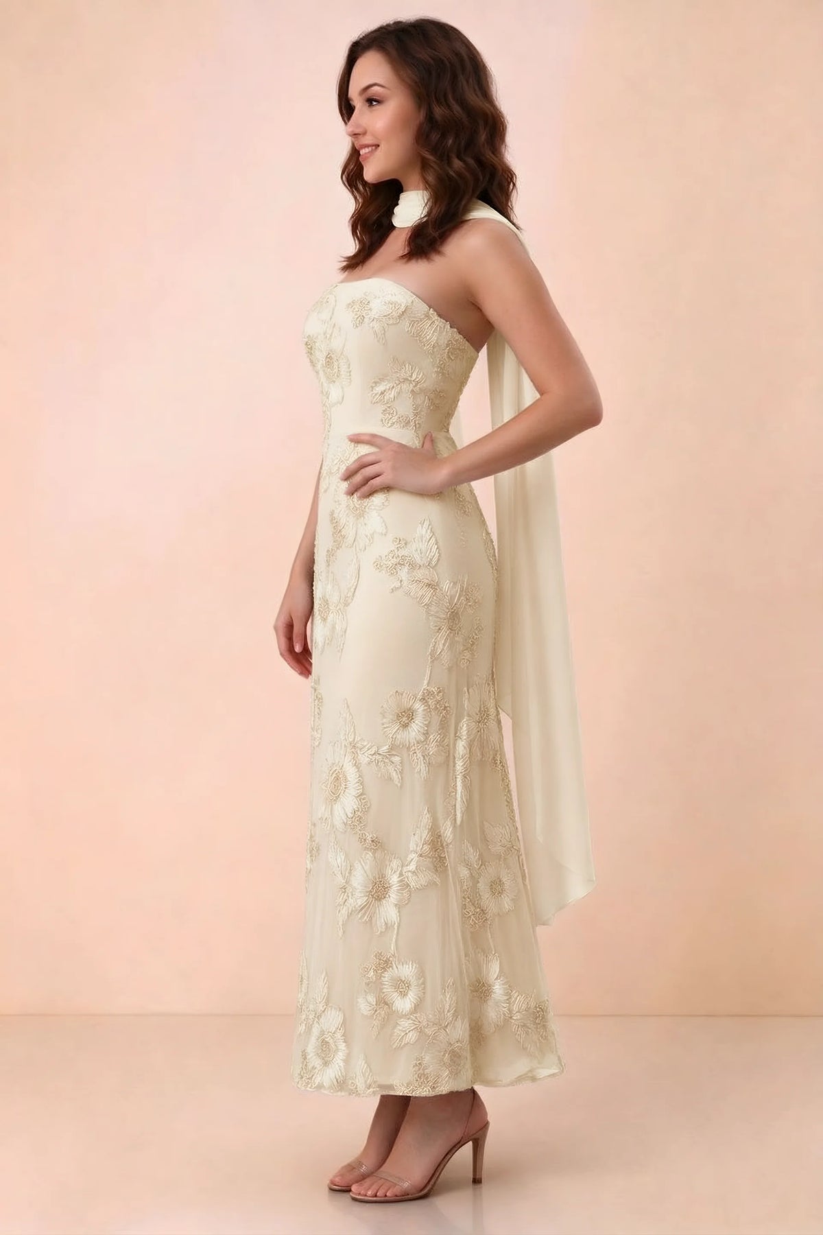 Three-quarter studio view of Carey yellow strapless dress showing the fitted waist and floral appliques