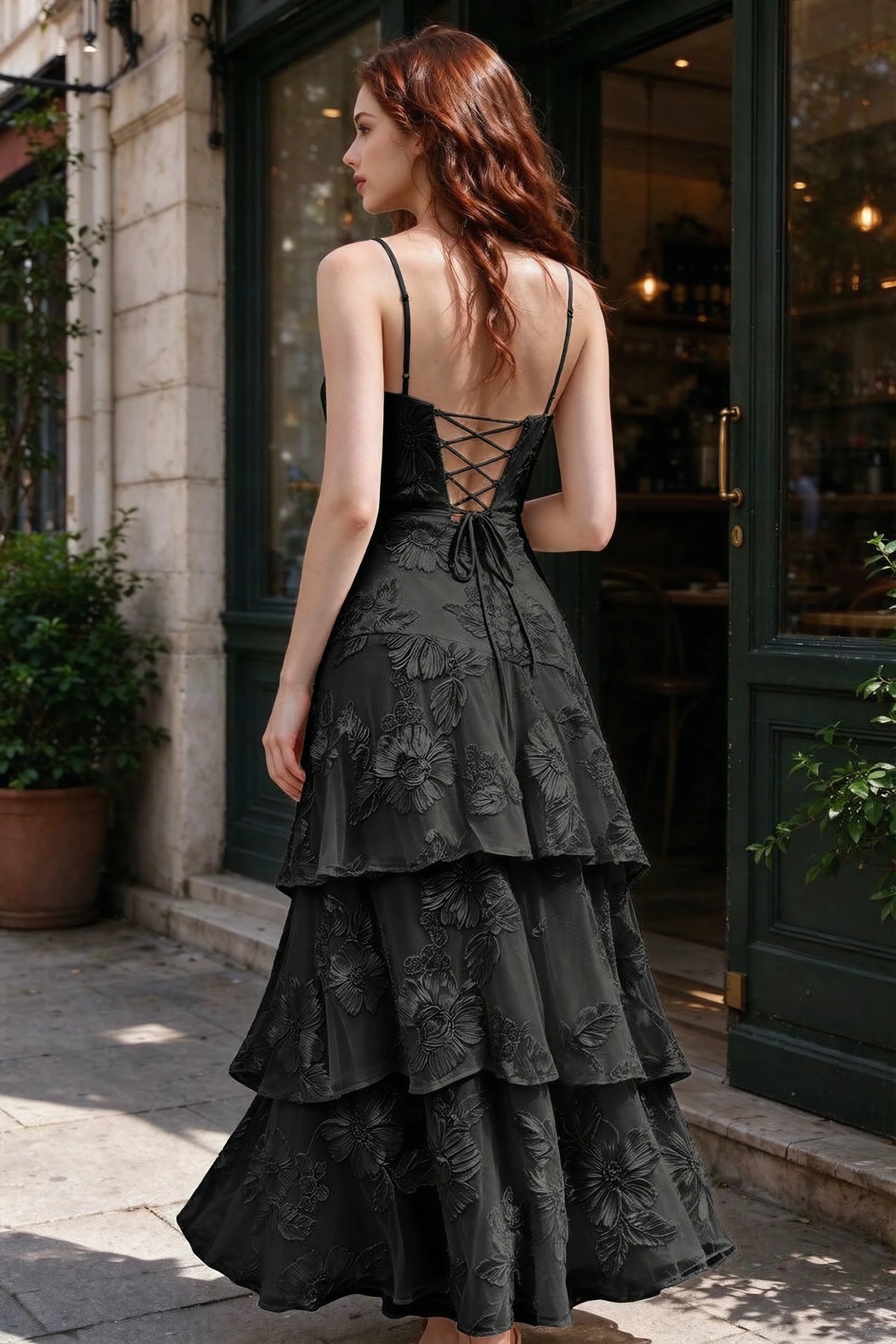 Outdoor rear view of Bonnie black dress showing the lace-up back and layered skirt