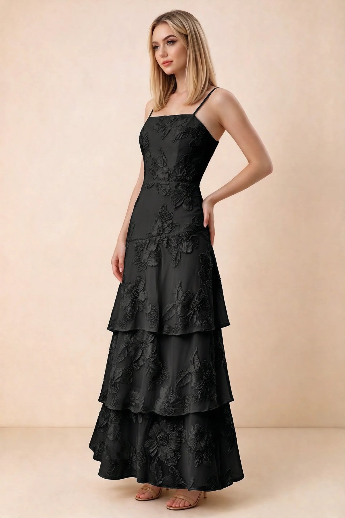Three-quarter studio view of Bonnie black dress showing the fitted waist and flared ruffle tiers