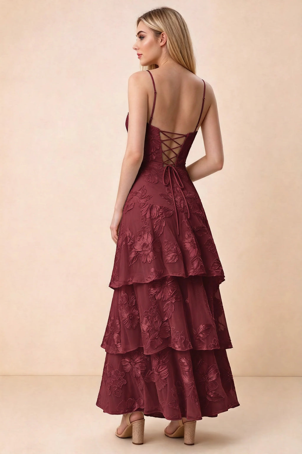 Rear studio view of Bonnie burgundy dress showing adjustable straps, back lacing and tiered ruffles