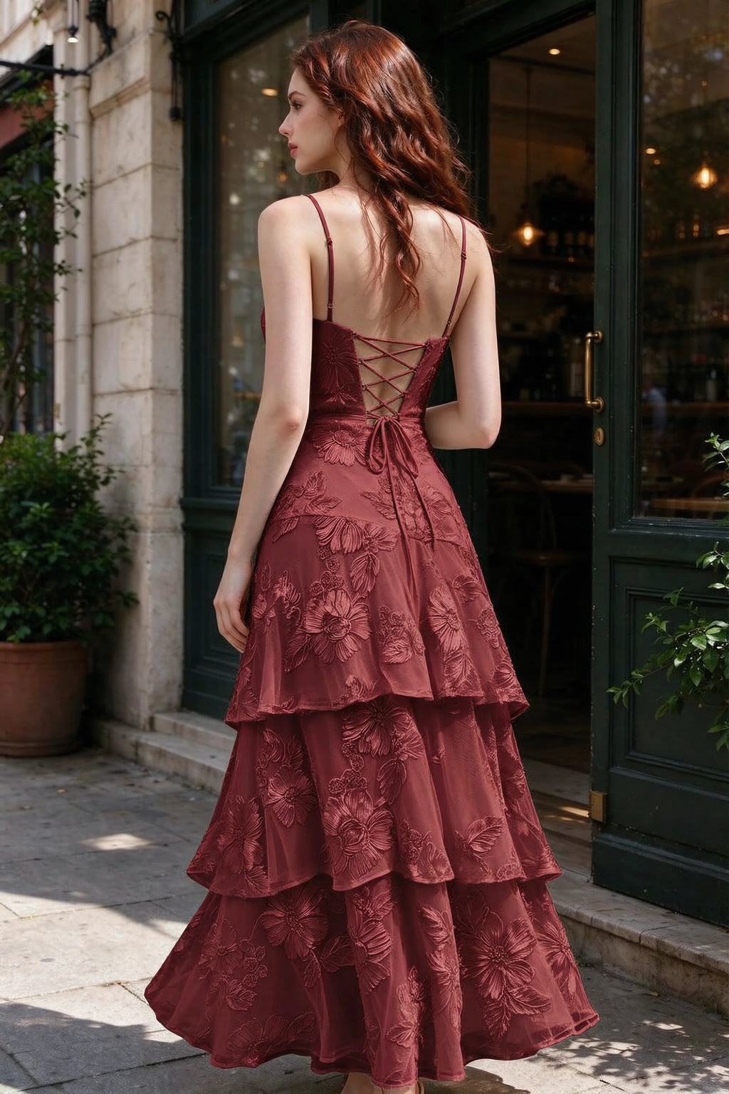 Outdoor rear view of Bonnie burgundy dress showing the lace-up back and layered skirt