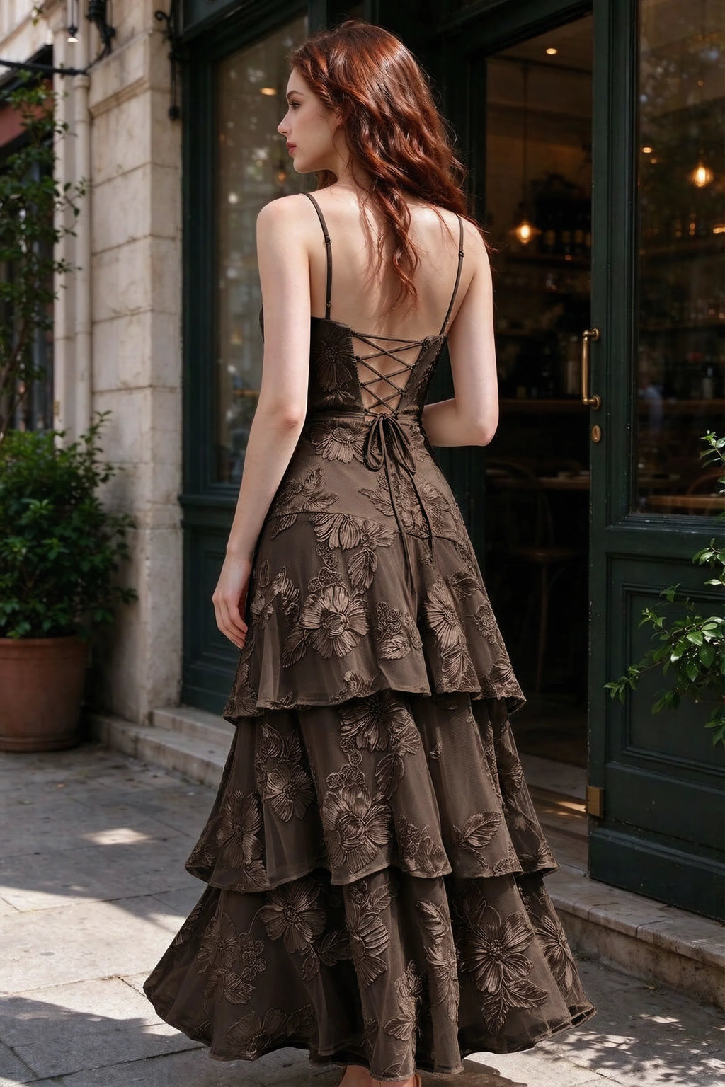Outdoor rear view of Bonnie chocolate dress showing the lace-up back and layered skirt