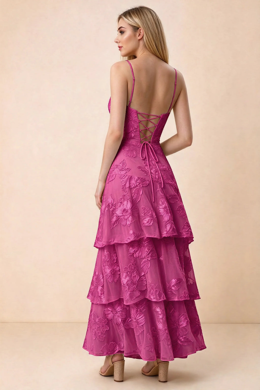 Rear studio view of Bonnie fuchsia dress showing adjustable straps, back lacing and tiered ruffles