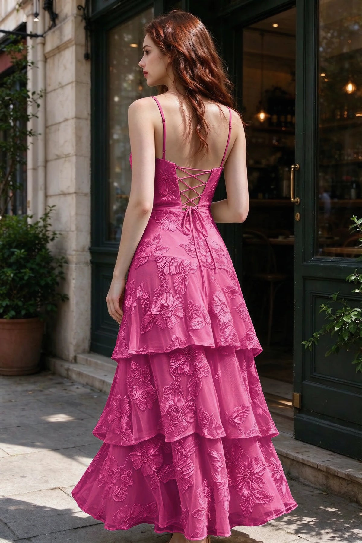 Outdoor rear view of Bonnie fuchsia dress showing the lace-up back and layered skirt
