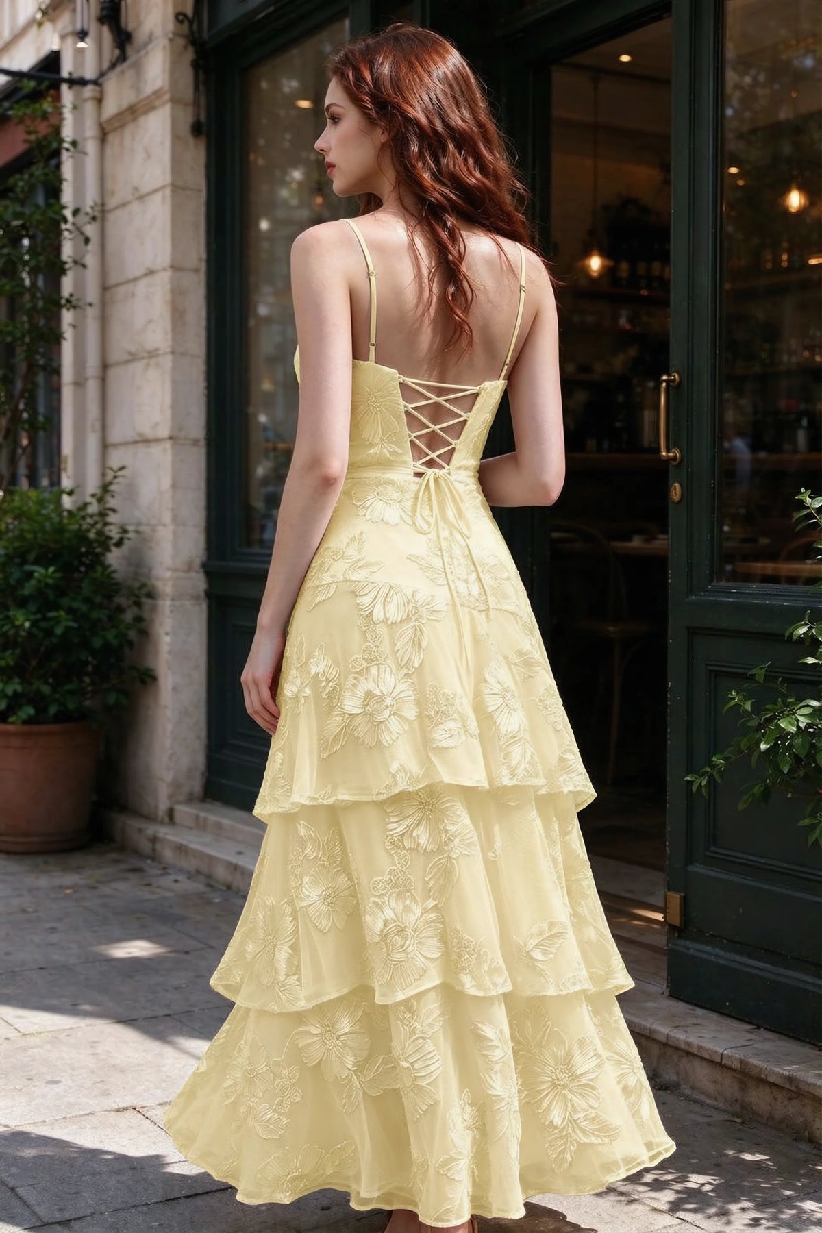 Outdoor rear view of Bonnie lemon dress showing the lace-up back and layered skirt