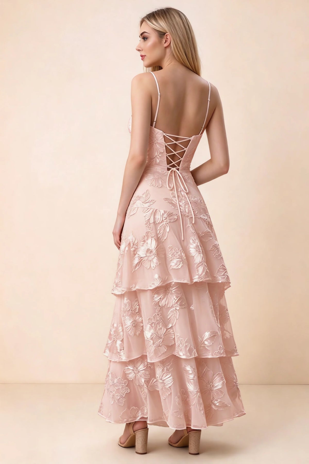 Rear studio view of Bonnie light pink dress showing adjustable straps, back lacing and tiered ruffles