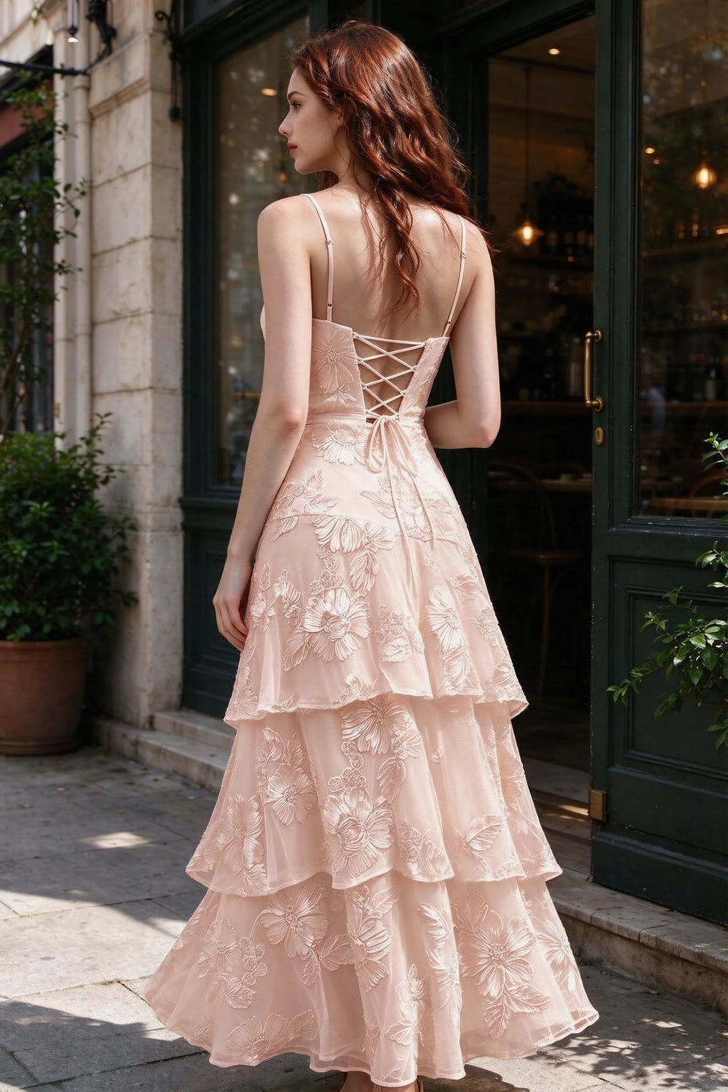 Outdoor rear view of Bonnie light pink dress showing the lace-up back and layered skirt
