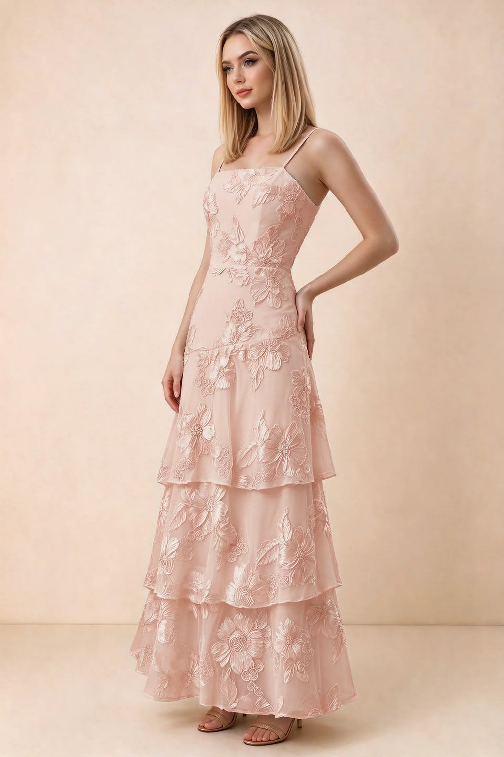 Three-quarter studio view of Bonnie light pink dress showing the fitted waist and flared ruffle tiers