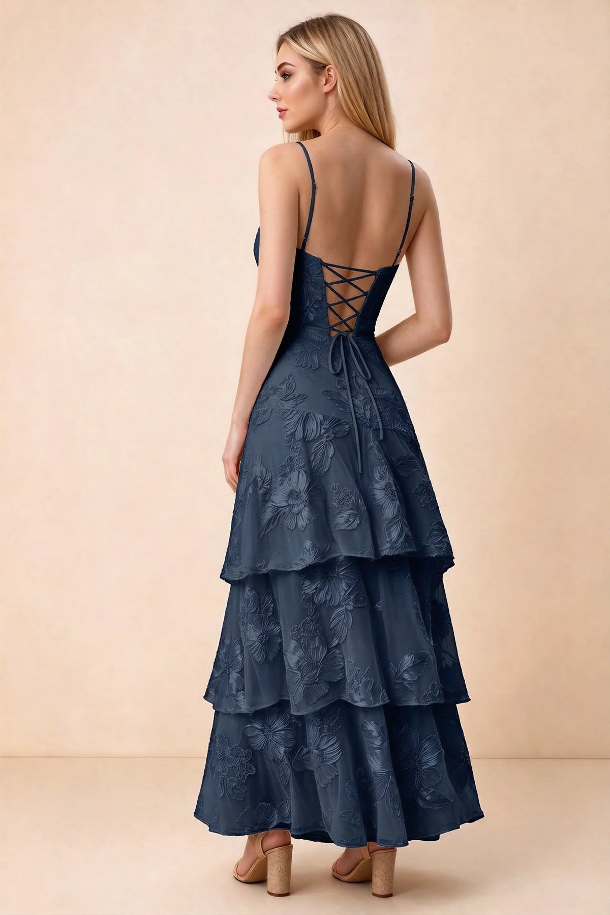 Rear studio view of Bonnie navy dress showing adjustable straps, back lacing and tiered ruffles
