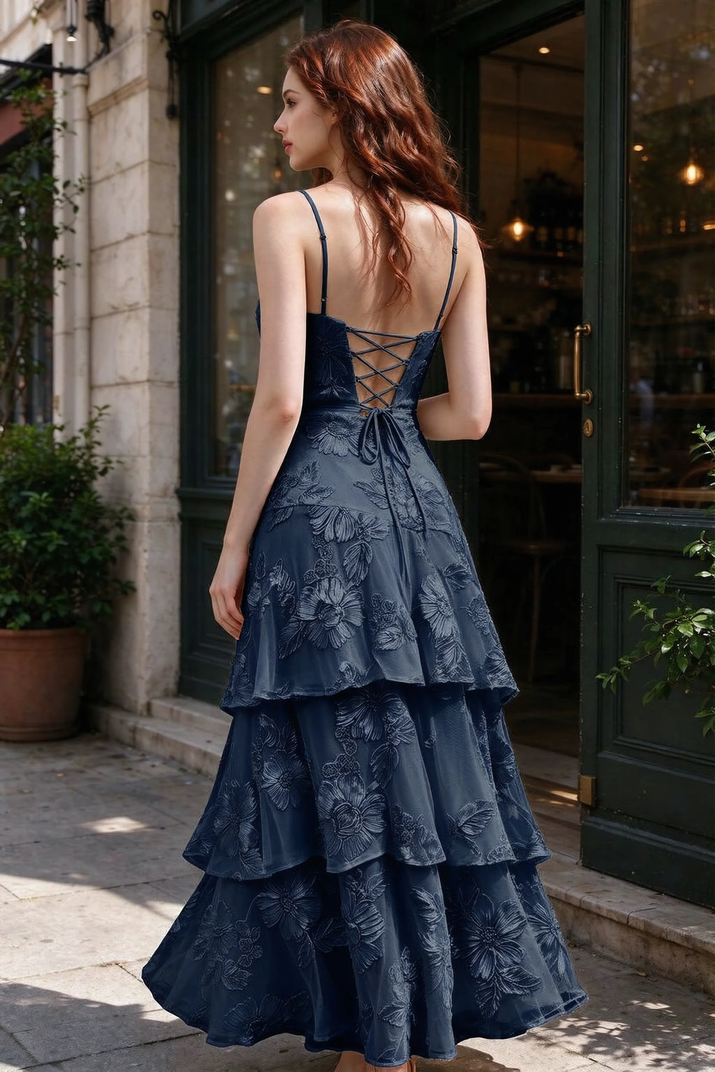 Outdoor rear view of Bonnie navy dress showing the lace-up back and layered skirt