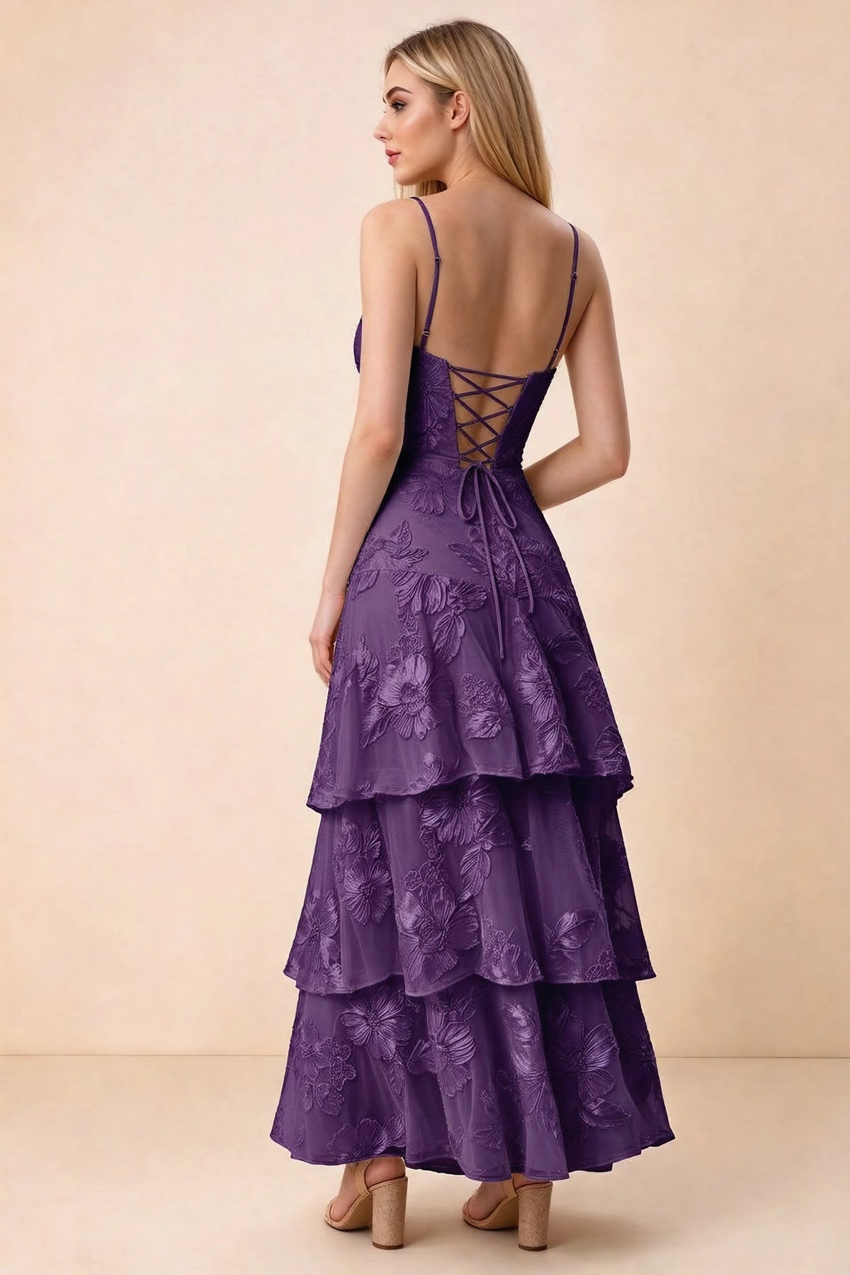 Rear studio view of Bonnie plum dress showing adjustable straps, back lacing and tiered ruffles