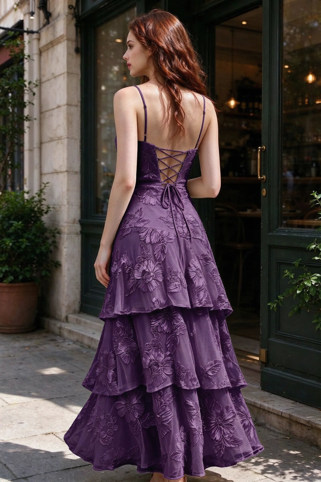 Outdoor rear view of Bonnie plum dress showing the lace-up back and layered skirt