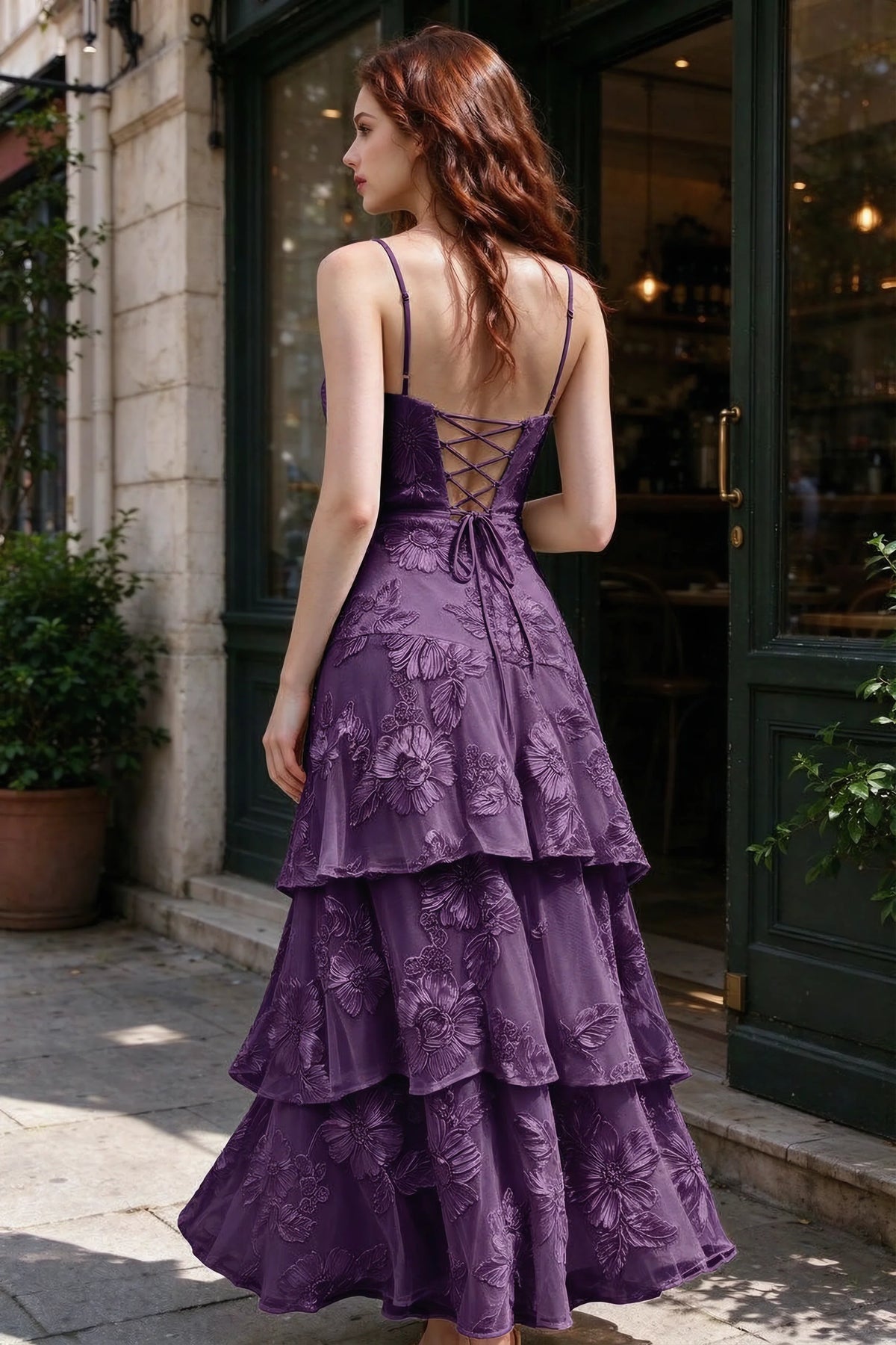 Outdoor rear view of Bonnie plum dress showing the lace-up back and layered skirt
