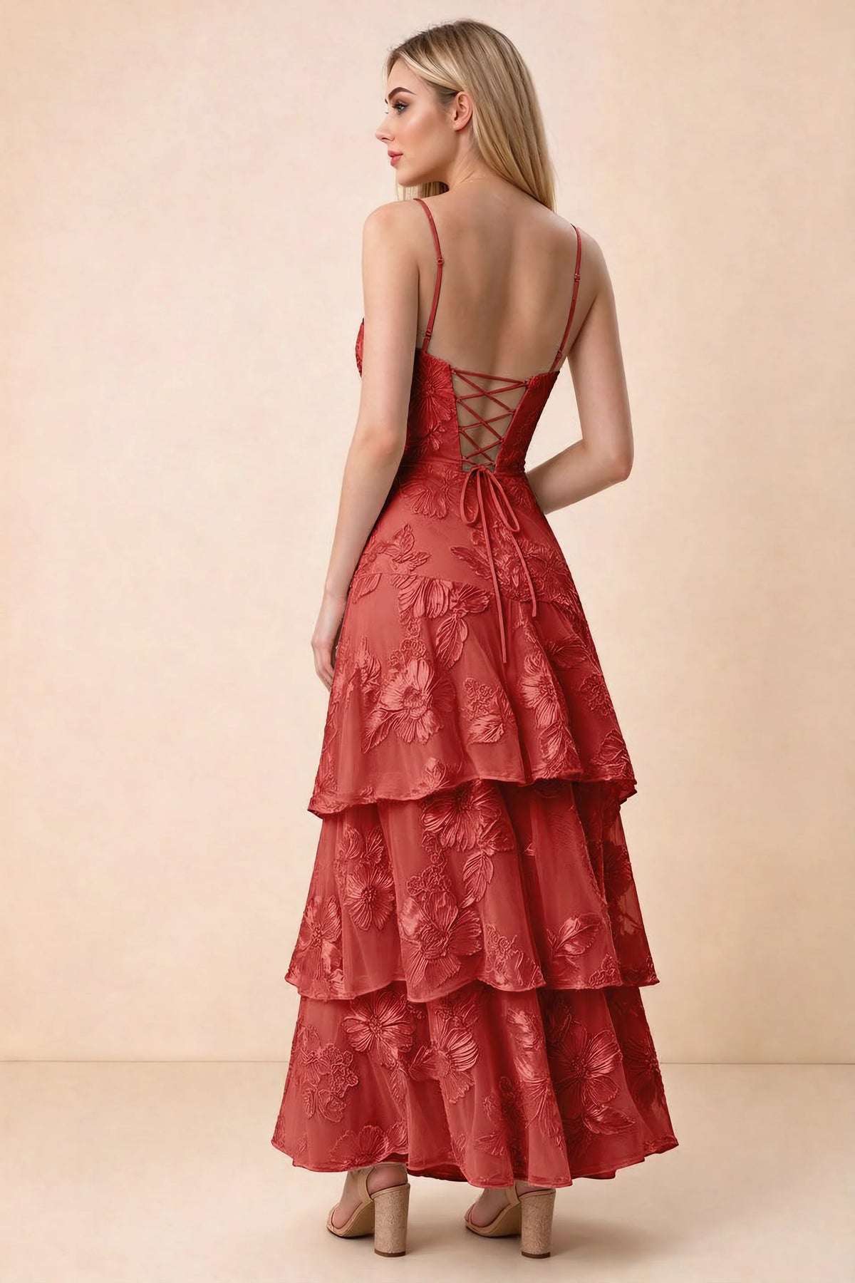 Rear studio view of Bonnie red dress showing adjustable straps, back lacing and tiered ruffles