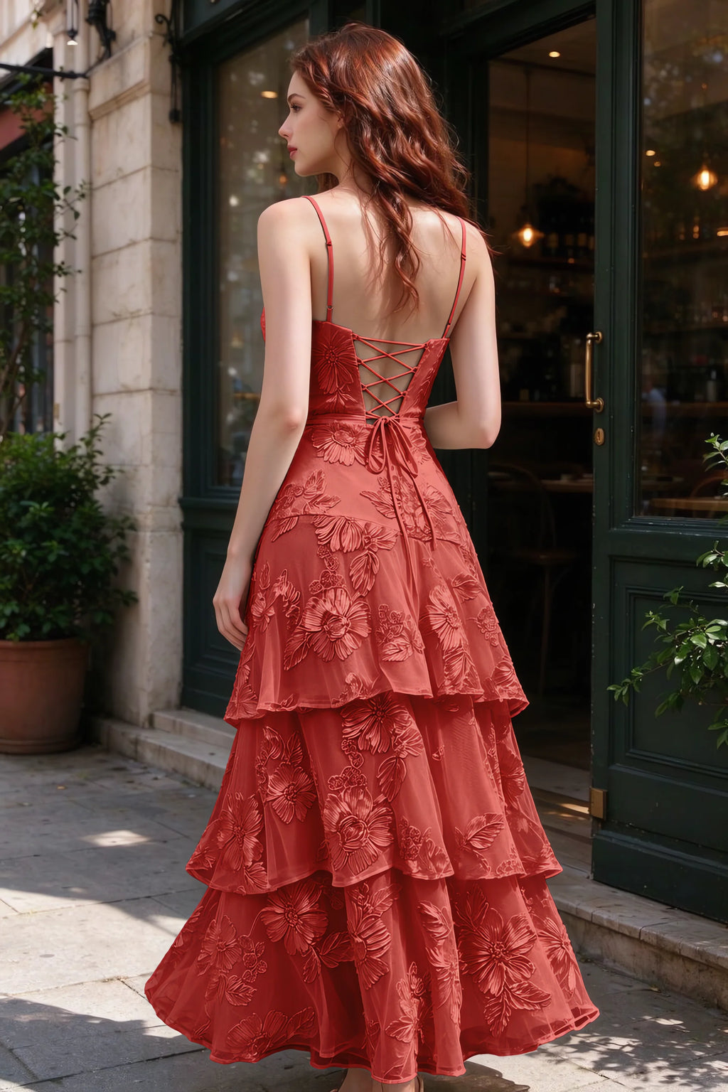 Outdoor rear view of Bonnie red dress showing the lace-up back and layered skirt