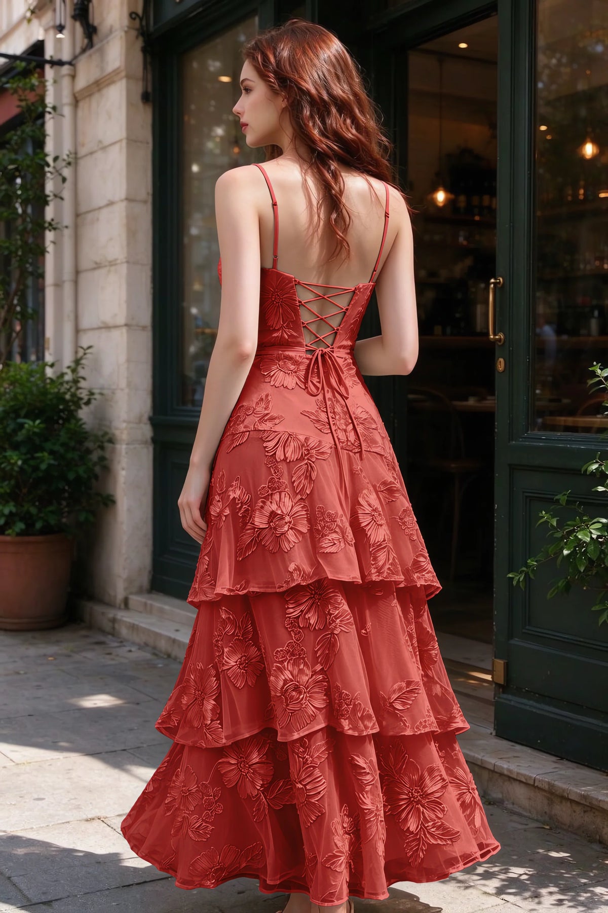 Outdoor rear view of Bonnie red dress showing the lace-up back and layered skirt