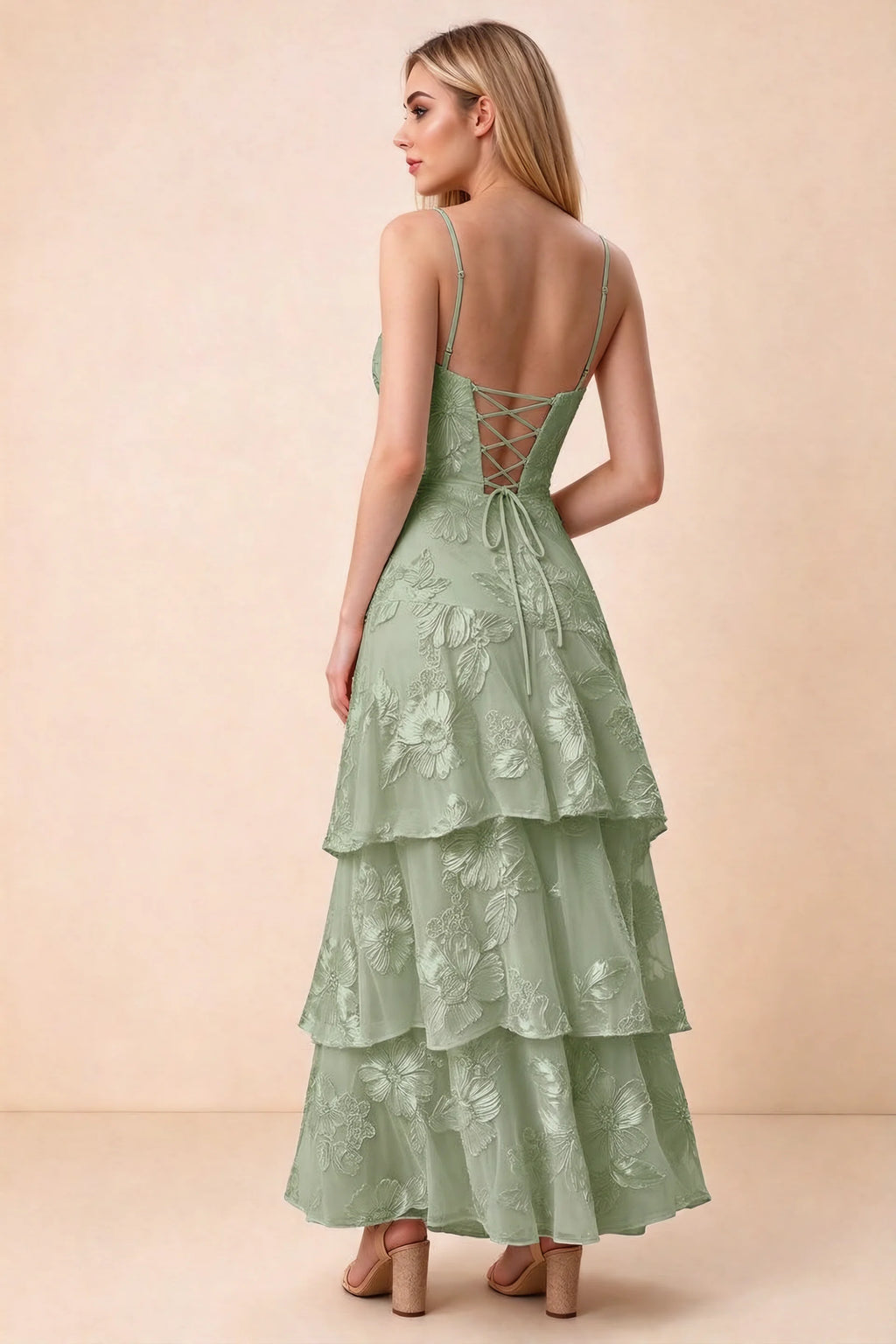 Rear studio view of Bonnie sage green dress showing adjustable straps, back lacing and tiered ruffles