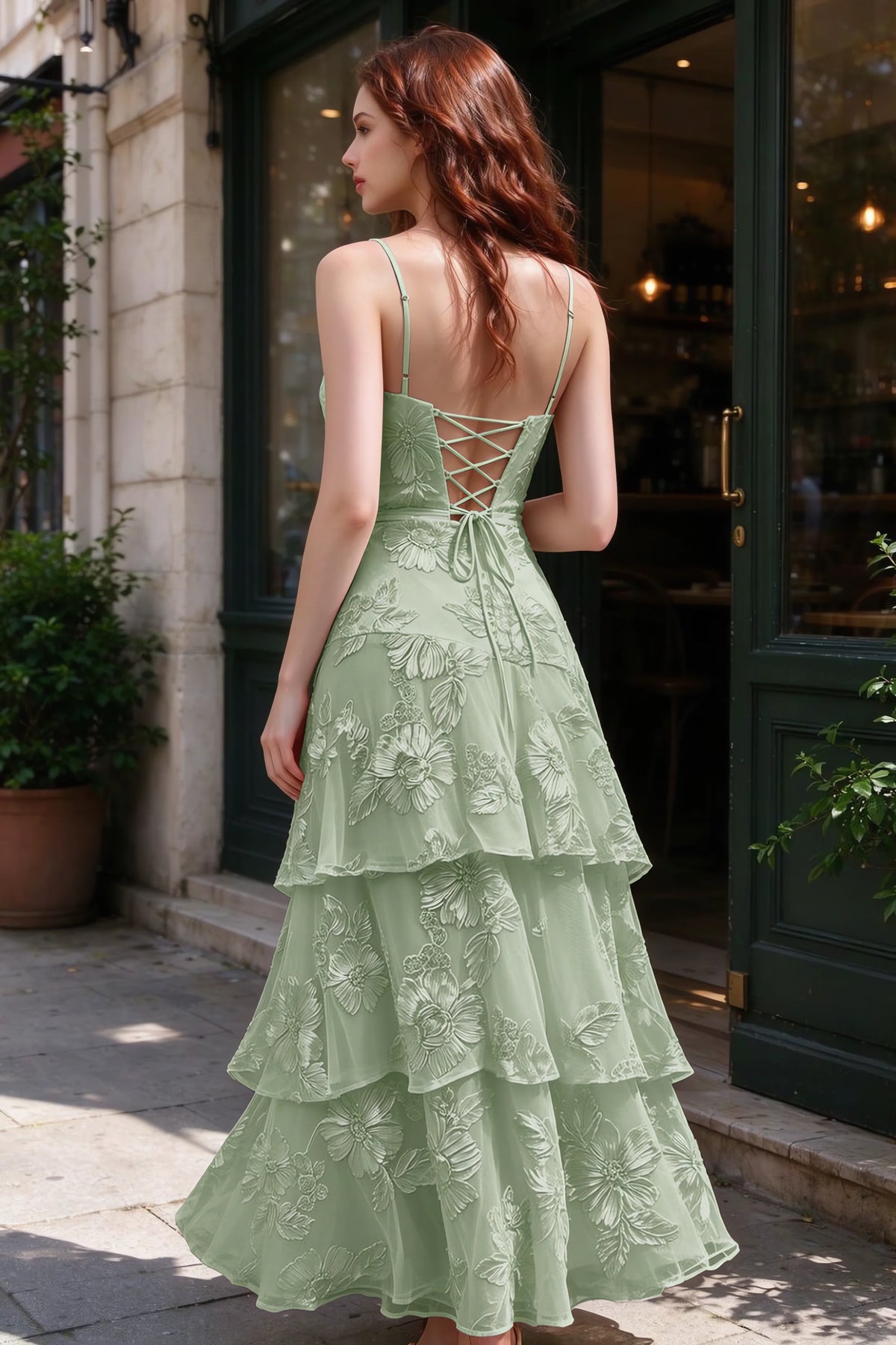 Outdoor rear view of Bonnie sage green dress showing the lace-up back and layered skirt