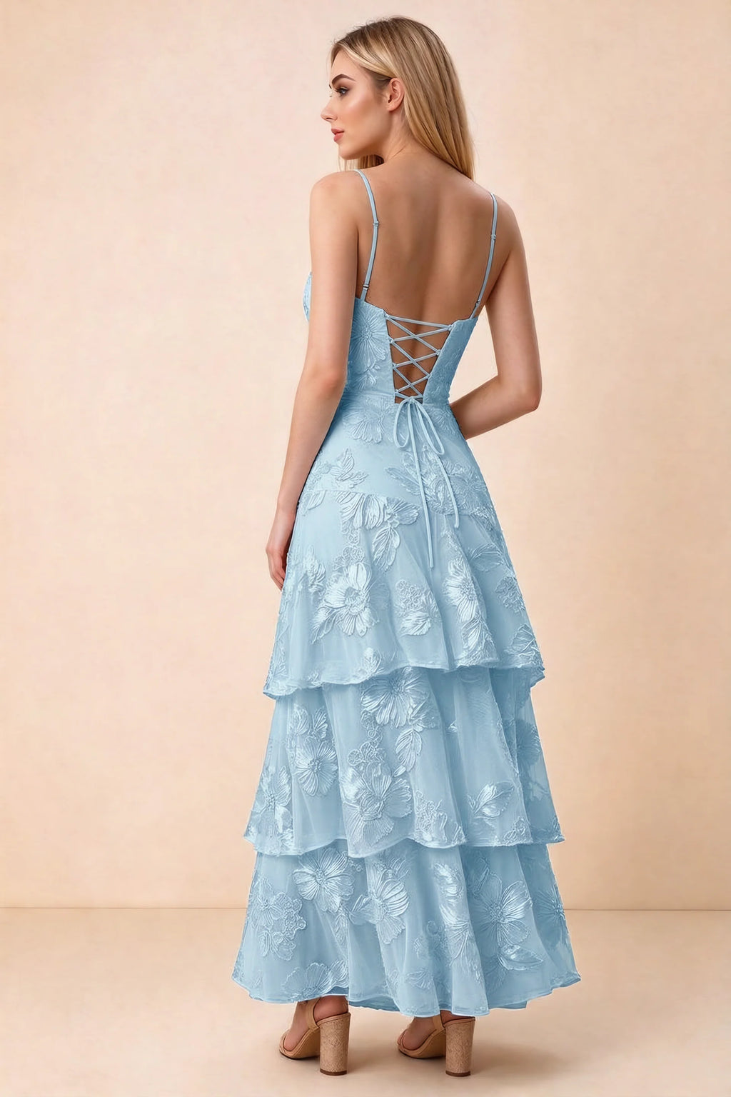Rear studio view of Bonnie sky blue dress showing adjustable straps, back lacing and tiered ruffles