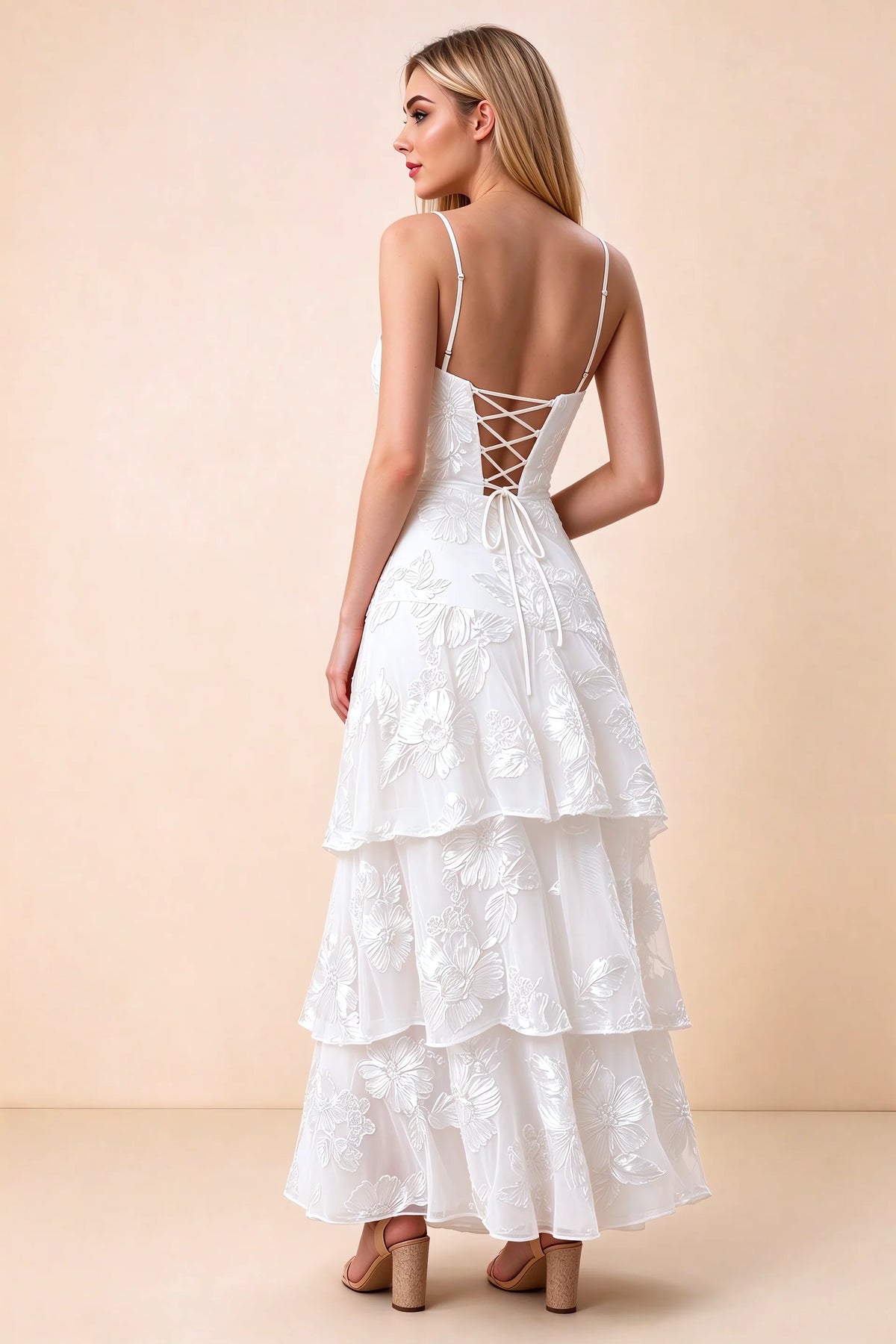 Rear studio view of Bonnie white dress showing adjustable straps, back lacing and tiered ruffles