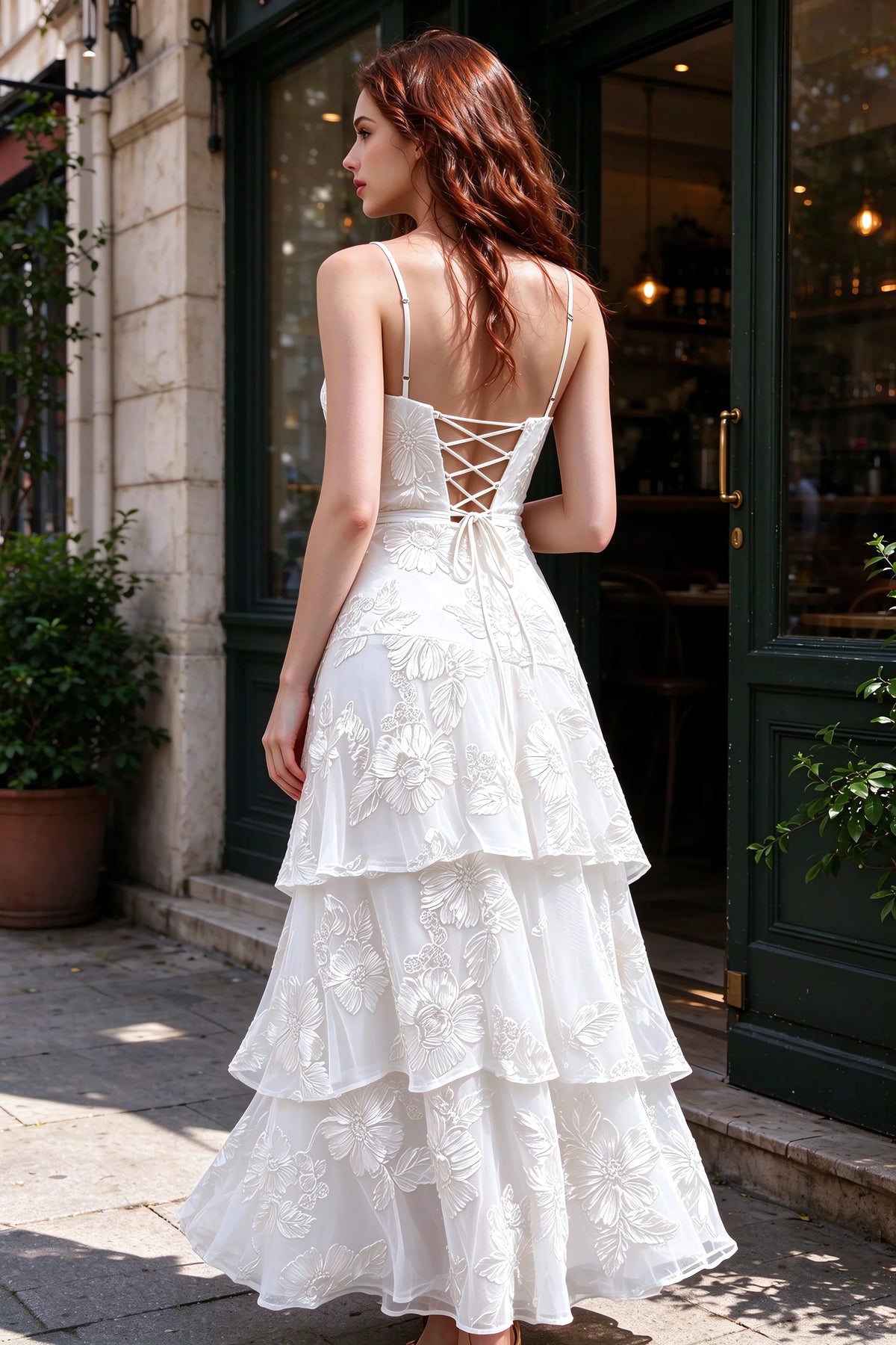 Outdoor rear view of Bonnie white dress showing the lace-up back and layered skirt