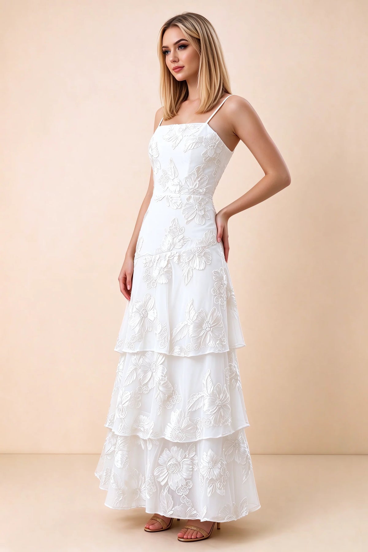 Three-quarter studio view of Bonnie white dress showing the fitted waist and flared ruffle tiers