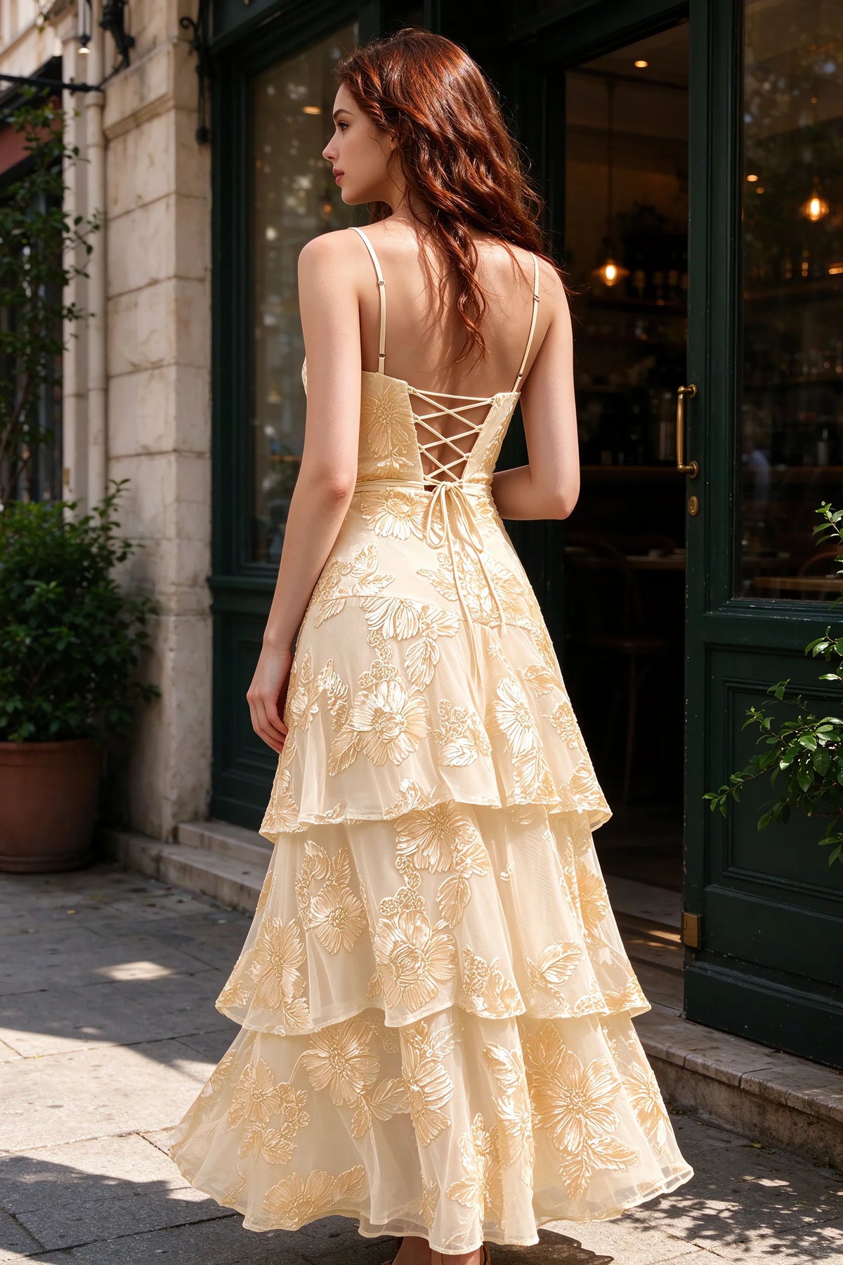 Outdoor rear view of Bonnie yellow dress showing the lace-up back and layered skirt