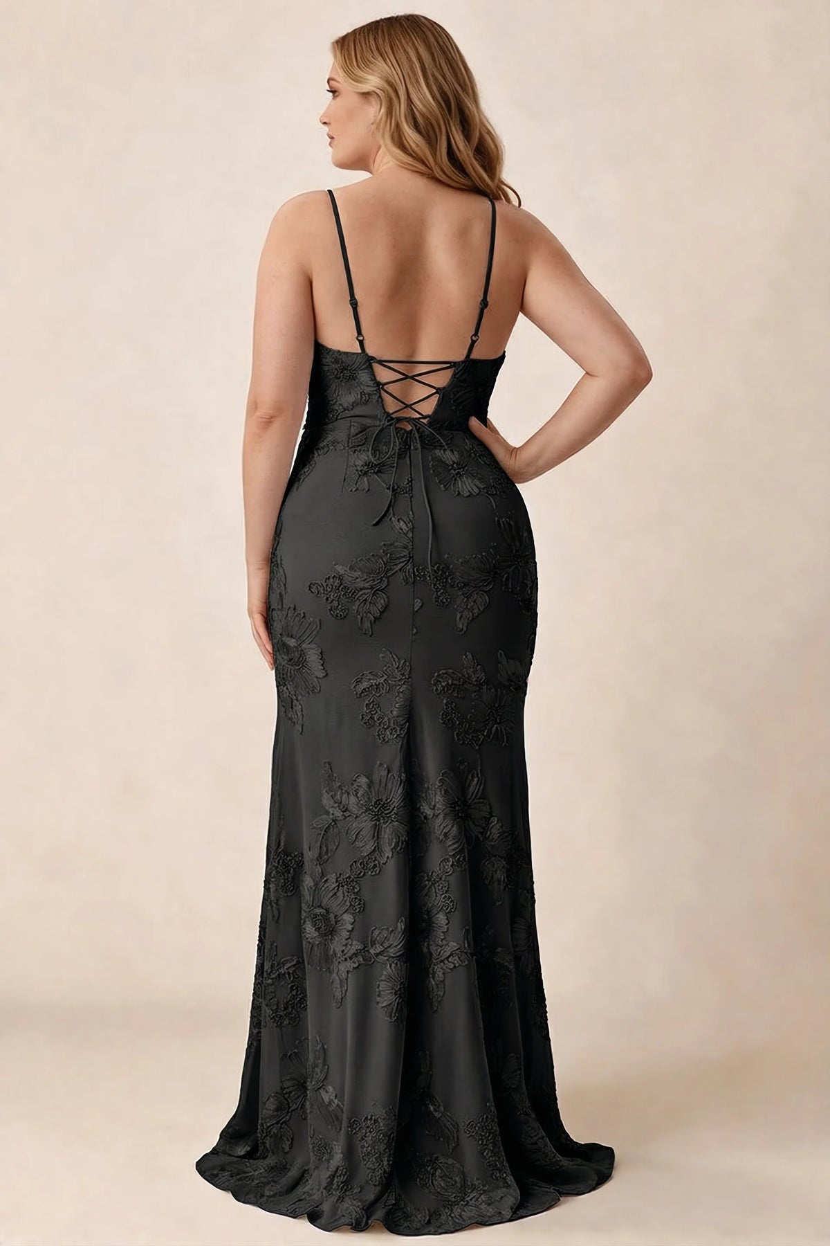 Rear studio view of Brianna black floral dress showing the fitted hips and long hem