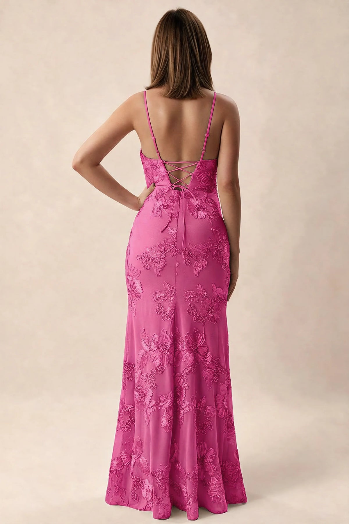 Rear studio view of Brianna fuchsia dress showing adjustable shoulder straps and crossed back lacing