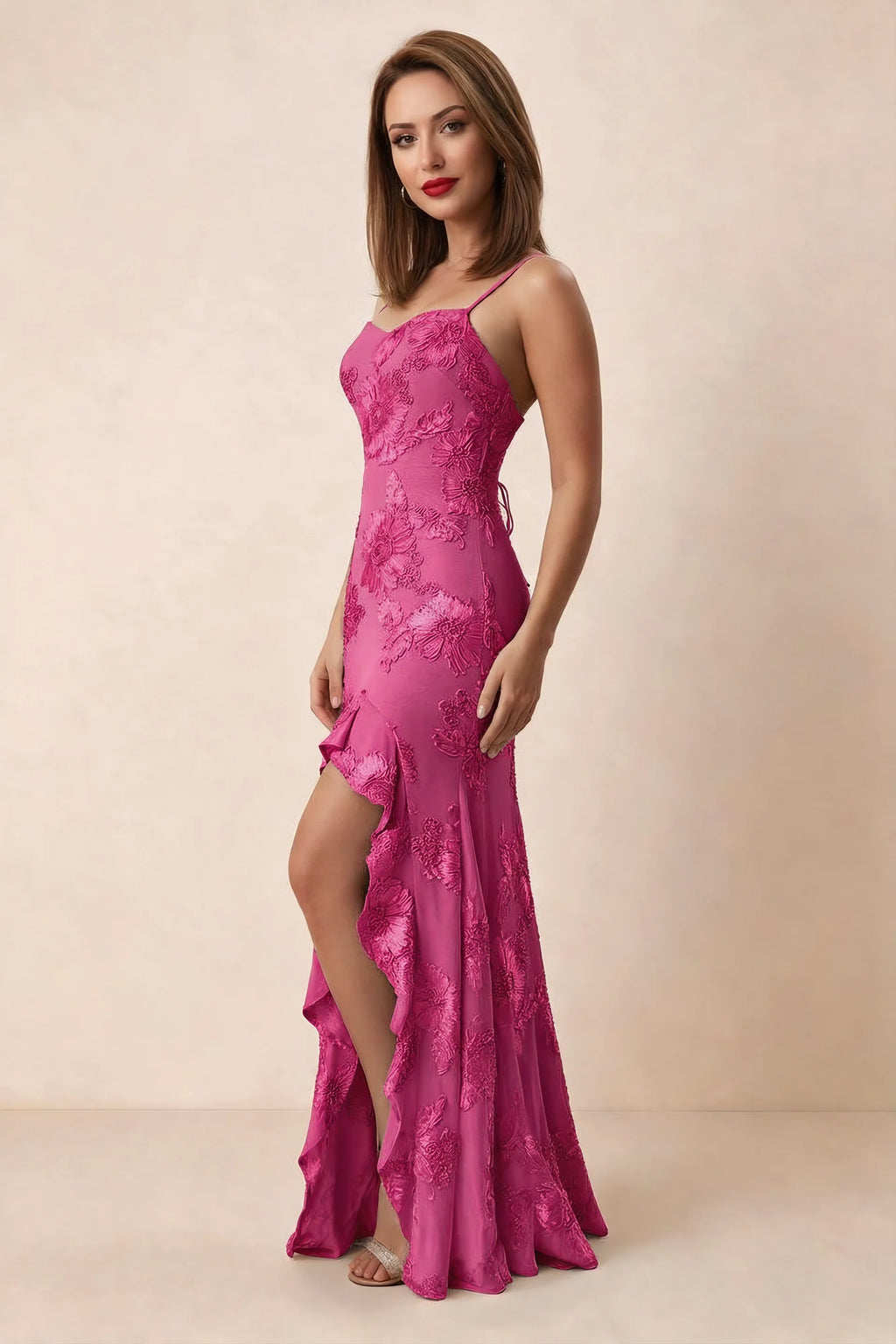 Three-quarter studio view of Brianna fuchsia dress showing cascading ruffles beside the high front opening