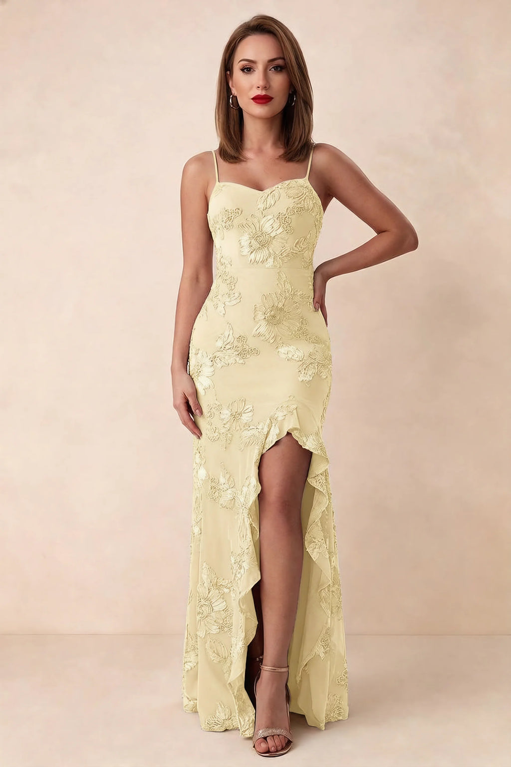 Front studio view of Brianna lemon floral maxi dress with thin straps and a high ruffle-edged opening